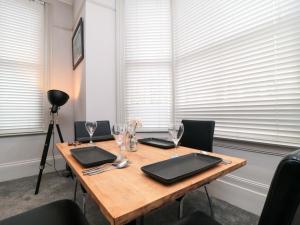 a wooden table with two laptops and wine glasses at Craven Suite in Scarborough +9 photos