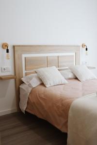 a bedroom with a bed with two pillows on it at Páteo da Chica in Cano +48 photos