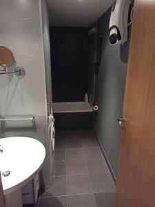 a bathroom with a sink and a bath tub at Altissim LaSolana in Pas de la Casa +2 photos