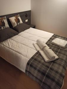 a bed with two pillows on top of it at Altissim LaSolana in Pas de la Casa