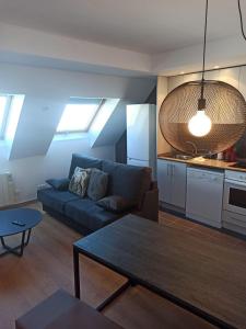 a living room with a couch and a table at Altissim LaSolana in Pas de la Casa