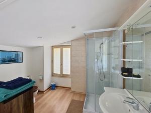 a bathroom with a glass shower and a sink at La Parenthese in Blyes +39 photos