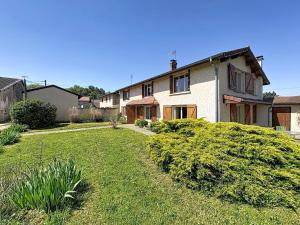 a large house with a yard in front of it at La Parenthese in Blyes