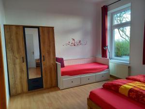 a bedroom with a mirror and a bed and a window at Ulfershausen in Wangerland +29 photos