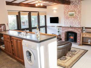 a kitchen and living room with a washer and dryer at The Granary in Bucknell