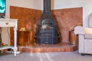 a fireplace in the corner of a room at Olive's Cottage in Molteno