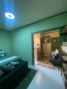 a room with a bed and a couch and a table at Chick Nina Loft in Barra do Garças