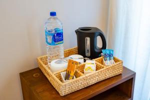 a wicker basket with a bottle of water on a table at Kandy Neela Weralu in Haragama +21 photos