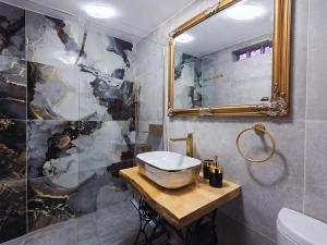 a bathroom with a sink and a shower and a mirror at Adria Stone House in Grižane