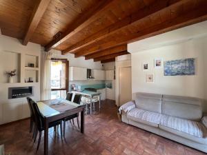 a living room with a couch and a table at Copelia - Pool and Elegance in Paratico