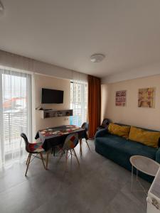 a living room with a couch and a table at Bakuriani apartment in Bakuriani