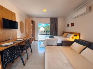 a hotel room with a bed and a couch at Centro - flat completo para 4 pessoas in Brusque