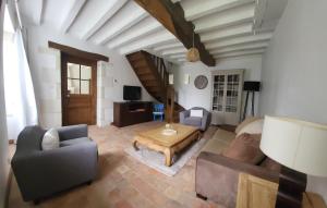 a living room with a couch and a table at La Petite Rochette in Chédigny