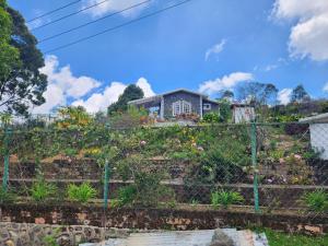 a garden in front of a house at Hideout by Cloudwalks in Kodaikānāl