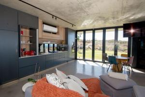a large living room with a couch and a table at Walvishaai in Stompneusbaai