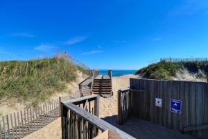 a stairway leading down to a beach with the ocean at 6155 - Designed to Please in Nags Head