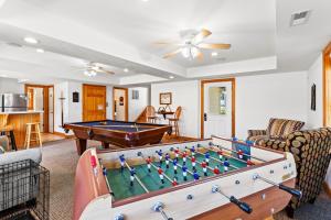 a living room with a pool table at 6155 - Designed to Please in Nags Head