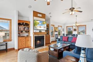 a living room with a couch and a fireplace at 6155 - Designed to Please in Nags Head