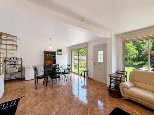 a living room with a table and chairs at La Parenthese in Blyes