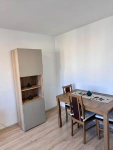 a dining room with a table and a refrigerator at Metro Central 3 Rooms Apartment in Warsaw