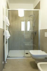 a bathroom with a shower and a toilet at North Wind Camping & Apartment in Domaso +175 photos