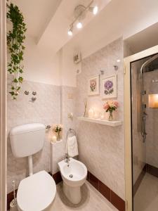 a white bathroom with a toilet and a shower at B&B Giulia in Taormina