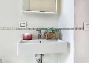 a white sink in a bathroom with a mirror at Holihome Hill View in Tortoreto Lido +38 photos