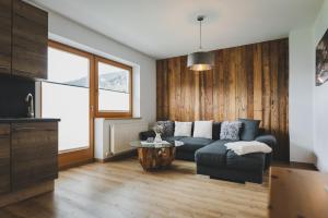 a living room with a couch and a table at Apartpension Oberhauser in Kaprun