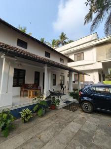 a car parked in front of a house at beach homestay sea view in Kannur