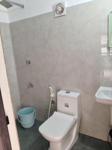 a bathroom with a toilet and a sink at beach homestay sea view in Kannur