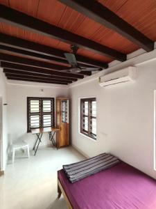 a bedroom with a large purple bed in a room at beach homestay sea view in Kannur