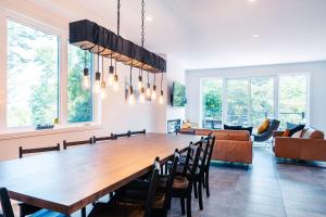 a dining room with a large wooden table and chairs at Le Yéti de Tremblant in La Conception +78 photos