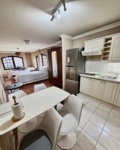 a kitchen with a table and chairs and a room at Aragonés departamentos in Temuco
