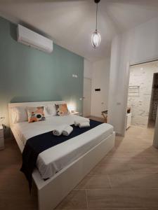 a bedroom with a large bed in a room at Townhouse 41 - by Be Your Home in Civitavecchia