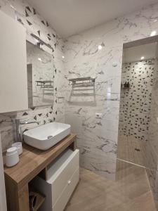 a white bathroom with a sink and a shower at Townhouse 41 - by Be Your Home in Civitavecchia