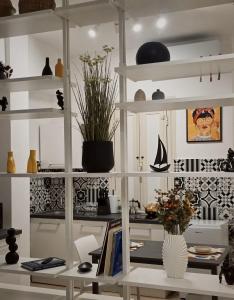 a room with white shelves with vases and a desk at Townhouse 41 - by Be Your Home in Civitavecchia +29 photos