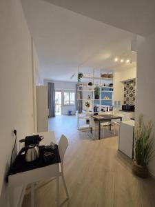 a kitchen and living room with a table and chairs at Townhouse 41 - by Be Your Home in Civitavecchia