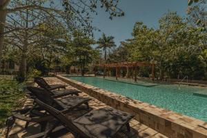 ein Swimmingpool mit Stühlen und einem Pavillon in der Unterkunft Villas Marlé in Mococha