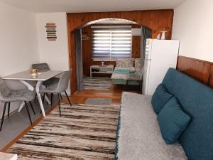 a living room with a couch and a table at Studio 28 in Bajina Bašta