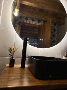 a bathroom with a black sink and a mirror at Casa Rama D Oliveira in Barrada +33 photos