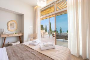 a bedroom with a bed and a large window at Veragi Boutique Villas in Lefkada +49 photos
