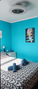 a blue bedroom with a bed with a blue wall at El Mirador de Murillo in Murillo de Río Leza