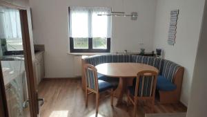a kitchen with a table and chairs and a couch at Haus Jörgbauerngut in Spielberg