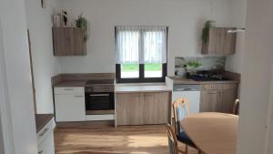 a kitchen with a table and a table and a window at Haus Jörgbauerngut in Spielberg