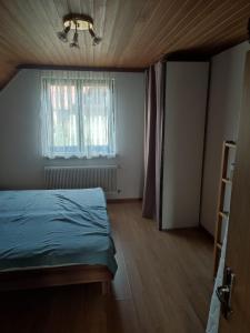 a small bedroom with a bed and a window at Haus Jörgbauerngut in Spielberg +2 photos