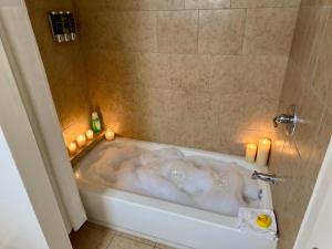 a bath tub with candles in a bathroom at Fox n Bear Cottages Big Bear in Big Bear Lake +58 photos