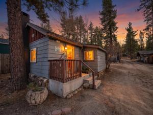 a small house with a porch in the woods at Fox n Bear Cottages Big Bear in Big Bear Lake