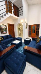 a large living room with blue couches and tables at Thambara Resort in Polonnaruwa