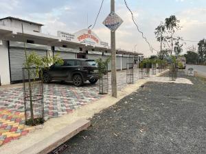 a car parked in a parking lot in front of a building at Shyam Hotel & Janmasa in Rewa