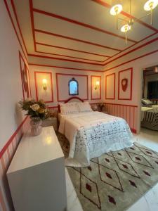 a bedroom with a bed and a table with a rug at Chick Nina Loft in Barra do Garças +17 photos